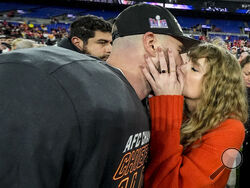  Taylor Swift kisses Kansas City Chiefs tight end Travis Kelce after an AFC Championship NFL football game against the Baltimore Ravens, Sunday, Jan. 28, 2024, in Baltimore. The Kansas City Chiefs won 17-10. (AP Photo/Julio Cortez)