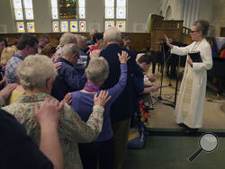 The Rev. Tracy Cox of First United Methodist Church and members of her congregation pray for Tracy Merrick, who will attend the United Methodist General Conference as a delegate representing Western Pennsylvania, as well as Anais Hussian and Joshua Popson who will also be in attendance, Sunday, April 14, 2024, in Pittsburgh. Hussian is a reserve delegate and Popson will be advocating for LGBTQ inclusion with the Love Your Neighbor Coalition. Many, including Rev. Cox, hope that this is the year they change l