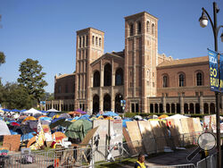 Pro-Palestinian protesters continued to occupy the grounds at University of California, Los Angeles in front of Royce Hall on Monday, April 29, 2024, in Los Angeles. Security has surrounded the encampment after a skirmish broke out Sunday between the Pro-Palestianian protesters and Israel supporters. (David Crane/The Orange County Register via AP)