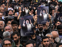 People hold up posters of President Ebrahim Raisi during a mourning ceremony for him at Vali-e-Asr square in downtown Tehran, Iran, Monday, May 20, 2024. Iranian President Raisi and the country's foreign minister were found dead Monday hours after their helicopter crashed in fog, leaving the Islamic Republic without two key leaders as extraordinary tensions grip the wider Middle East. (AP Photo/Vahid Salemi)