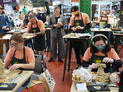 AP Photo/Matt Rourke The chief executive of the Philadelphia Museum of Art, Sasha Suda, center top, walks amongst competitors in the Scrapple Sculpting Contest at the Reading Terminal Market in Philadelphia Friday.