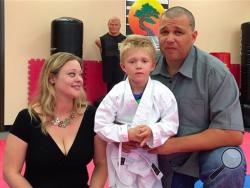 Liam Brenes, 4, with his parents, Amanda McFarland, and Frank Brenes at United Karate studio in Mission Viejo, Calif., on Tuesday, July 26, 2016. (Nick Koon/The Orange County Register via AP)
