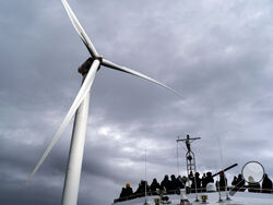 FILE Guests tour one of the turbines of America's first offshore wind farm, owned by the Danish company, Orsted, off the coast of Block Island, R.I., as part of a wind power conference, Oct. 17, 2022. A new AP-NORC poll shows that nearly two-thirds of Americans think the federal government is not doing enough to fight climate change, even as they have limited awareness about a sweeping new law that commits the U.S. to its largest ever investment to combat global warming. (AP Photo/David Goldman, File)