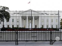 FILE - In this Sept. 22, 2014, file photo. the perimeter fence sits in front of the White House fence on the North Lawn along Pennsylvania Avenue in Washington. (AP Photo/Carolyn Kaster, File)