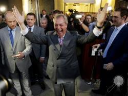 Nigel Farage, the leader of the UK Independence Party, celebrates and poses for photographers as he leaves a "Leave.EU" organization party for the British European Union membership referendum in London, Friday, June 24, 2016. On Thursday, Britain voted in a national referendum on whether to stay inside the EU. (AP Photo/Matt Dunham)