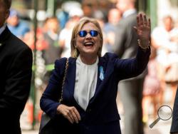 Democratic presidential candidate Hillary Clinton waves after leaving an apartment building Sunday, Sept. 11, 2016, in New York. Clinton's campaign said the Democratic presidential nominee left the 9/11 anniversary ceremony in New York early after feeling "overheated." (AP Photo/Andrew Harnik)