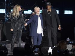 Jay Z, right, and Beyonce, left, stand with Democratic presidential candidate Hillary Clinton during a campaign rally in Cleveland, Friday, Nov. 4, 2016. (AP Photo/Matt Rourke)