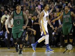 Boston Celtics' Isaiah Thomas (4) and Evan Turner (11) celebrate as time expires, and Golden State Warriors' Shaun Livingston (34) walks off the court at the end of an NBA basketball game Friday, April 1, 2016, in Oakland, Calif. Boston won 109-106. (AP Photo/Marcio Jose Sanchez)