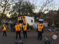 In this photo provided by the Chattanooga Fire Department via Chattanooga Times Free Press, Chattanooga Fire Department personnel work the scene of a fatal elementary school bus crash in Chattanooga, Tenn., Monday, Nov. 21, 2016. In a news conference Monday, Assistant Chief Tracy Arnold said there were multiple fatalities in the crash. (Bruce Garner/Chattanooga Fire Department via Chattanooga Times Free Press via AP)