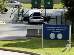 A car tangled in fencing sits parked just inside the gate at the Naval Operational Support Center and Marine Reserve Center where a gunman opened fire Thursday killing four U.S. Marines Friday, July 17, 2015, in Chattanooga, Tenn. (AP Photo/John Bazemore)
