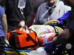 An injured female performer is lifted onto a stretcher after a platform collapsed during an aerial hair-hanging stunt at the Ringling Brothers and Barnum and Bailey Circus, Sunday, May 4, 2014, in Providence, R.I. At least nine performers were seriously injured in the fall, including a dancer below, while an unknown number of others suffered minor injuries. (AP Photo/Providence Journal, Bob Breidenbach)