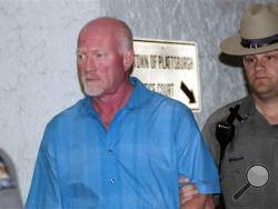 A New York State Police officer escorts suspended Clinton Correctional Facility guard Gene Palmer, left, from Plattsburgh Town Court in Plattsburgh, N.Y., Wednesday, June 24, 2015. (Rob Fountain/The Press-Republican via AP)