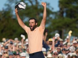 Scottie Scheffler celebrates his win at the Masters golf tournament at Augusta National Golf Club Sunday, April 14, 2024, in Augusta, Ga. (AP Photo/Ashley Landis)