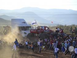 People run as an out of control monster truck plows through a crowd of spectators at a Mexican air show in the city of Chihuahua, Mexico, Saturday Oct. 5, 2013. According to authorities, at least 8 people were killed and 80 were injured. (AP Photo/El Diario de Chihuahua)