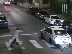 In this frame from a Thursday, Jan. 7, 2016 video provided by the Philadelphia Police Department, Edward Archer runs with a gun toward a police car driven by Officer Jesse Hartnett in Philadelphia. Archer, using a gun stolen from police, said he was acting in the name of Islam when he ambushed Hartnett sitting in his marked cruiser at an intersection, firing shots at point-blank range, authorities said. (Philadelphia Police Department via AP)