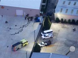 In this aerial photo, investigators work part of the shooting scene in Baton Rouge, La., where law enforcement officers were injured and killed, Sunday, July 17, 2016. (AP Photo/Gerald Herbert)