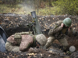 Ukrainian soldiers fire a mortar in the front line near Bakhmut, in the Donetsk region, Ukraine, Thursday, Oct. 27, 2022. (AP Photo/Efrem Lukatsky)