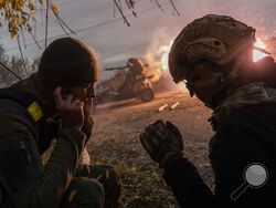 Ukrainian servicemen fire towards Russian positions in the frontline near Kherson, southern Ukraine, Wednesday, Nov. 23, 2022. (AP Photo/Bernat Armangue)
