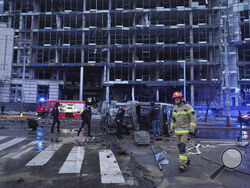 First responders work the scene following a Russian missile attack in Kyiv, Ukraine, Saturday, Jan. 18, 2025. (AP Photo/Efrem Lukatsky)