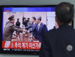 A man watches a TV news program reporting South Korea and North Korea reached an agreement, at the Seoul Railway Station, South Korea, Tuesday, Aug. 25, 2015. (AP Photo/Ahn Young-joon)