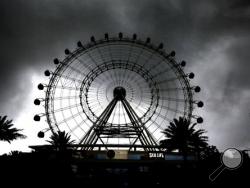Storm clouds from Tropical Storm Colin flank The Orlando Eye Ferris wheel in Orlando, Fla., as severe weather moves into central Florida, Monday, June 6, 2016. Heavy rains from Colin hit north Florida and southern Georgia on Monday, knocking out power in some areas and flooding roads on the Gulf coast. (Joe Burbank/Orlando Sentinel via AP) 