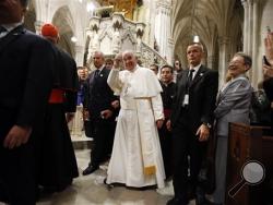 Pope Francis, center, gives a thumbs up sign after leading an evening prayer service at St. Patrick's Cathedral, Thursday, Sept. 24, 2015, in New York. (AP Photo/Jason DeCrow)