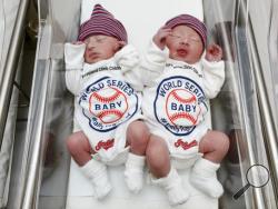 Unidentified babies wear World Series onesie at the Cleveland Clinic's Fairview Hospital in Cleveland on Tuesday, Oct. 25, 2016. Newborn babies at the Cleveland hospital have joined the ranks of the Cleveland Indians' fans. The clinic says babies born today and throughout the World Series at several of its hospitals will be dressed in the outfits to help cheer on the Indians' quest for a championship as they take on the Chicago Cubs. The first game of the series was set for Tuesday in Cleveland. (Cleveland 