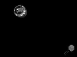 This image released by the Japan Aerospace Exploration Agency (JAXA) shows an explosive dropped from Hayabusa2 spacecraft to make a crater on the asteroid Ryugu Friday, April 5, 2019. Japan's space agency JAXA said its Hayabusa2 spacecraft successfully dropped the "small carry-on impactor" made of copper onto the asteroid and collect its underground samples to find possible clues to the origin of the solar system. (JAXA via AP)