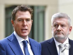 Australia's Attorney-General Christian Porter, left, and Minister for Communications Mitch Fifield hold a press conference at Parliament House, in Canberra, Wednesday, April 4, 2019. Australia's Parliament passed legislation that could imprison social media executives if their platforms stream violent images such as the New Zealand mosque shootings. (Mick Tsikas/AAP Image via AP)