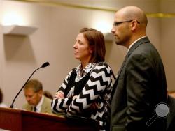 Cameo Adawn Crispi appears with her attorney, Clint Hendricks, public defender, foreground, in 8th District Court for a preliminary hearing in Vernal, Utah on Wednesday, Aug. 27, 2014. Crispi, 32, is accused of trying to set fire to her ex-boyfriend's home with a pound of bacon left burning on a gas stove. (AP Photo/Deseret News, Geoff Liesik, Pool)