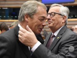 A Tuesday, June 28, 2016 photo from files showing European Commission President, Jean-Claude Juncker, right, greeting United Kingdom Independence Party leader, Nigel Farage, during a special session of European Parliament in Brussels on Tuesday. Farage announced on Monday July 4, 2016 that he is resigning as leader of the party. (AP Photo/Geert Vanden Wijngaert, File)