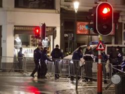 Police set up a barricade during an operation in the center of Brussels on Sunday, Nov. 22, 2015. (AP Photo/Virginia Mayo)