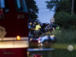 Police and rescue workers work at the scene of a western Michigan bicycle accident that left five people dead. (Chelsea Purgahn/Kalamazoo Gazette-MLive Media Group via AP)