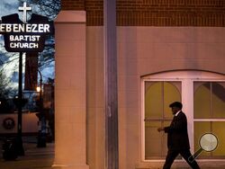 FILE - A man walks past Ebenezer Baptist Church, early Monday, Jan. 16, 2017, in Atlanta. President Joe Biden is set to mark what would have been the 94th birthday of the late Martin Luther King with a Sunday sermon at Atlanta's historic Ebenezer Baptist Church that aims to celebrate the civil rights leader's legacy while reviving his administration's call for sweeping voting rights reform. (AP Photo/Branden Camp, File)