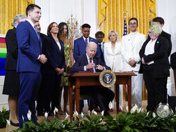 FILE - President Joe Biden signs an executive order at an event to celebrate Pride Month in the East Room of the White House, June 15, 2022, in Washington. Biden plans to sign legislation this coming week that will protect gay unions even if the Supreme Court revisits its ruling supporting a nationwide right of same-sex couples to marry. It's the latest part of Biden's legacy on gay rights, which includes his unexpected endorsement of marriage equality on national television a decade ago when he was vice pr