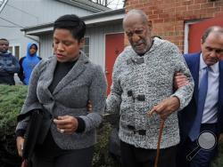 Actor and comedian Bill Cosby is helped as he leaves after a court appearance, Wednesday, Dec. 30, 2015, in Elkins Park, Pa. Cosby was arrested and charged with drugging and sexually assaulting a woman at his home in January 2004. (Tom Gralish/The Philadelphia Inquirer via AP) 