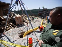 Border Patrol Special Operations Supervisor Cesar Sotelo looks on in front of the entrance to a tunnel leading to Mexico from a lot along the border, Wednesday, April 20, 2016, in San Diego. Officials announced the recent discovery of the nearly half-mile-long tunnel Wednesday, along with seizure of more than a ton of cocaine and seven tons of marijuana was seized. Six people were arrested. (AP Photo/Gregory Bull)