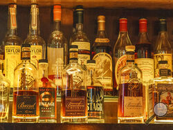 A collection of bottles of Pappy Van Winkle bourbons are seen on the top shelf right, among other fine whiskies at the "Far Bar," located in the historic Far East Building in the heart of Little Tokyo in Los Angeles on Saturday, March 4, 2023. Buttery, smooth, oaky. These are characteristics of the best bourbons, and a growing cult of aficionados is willing to pay an astonishing amount of money for these increasingly scarce premium spirits — and even bend or break laws. (AP Photo/Damian Dovarganes)
