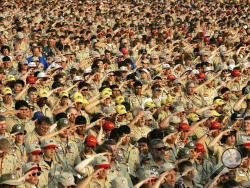 In this July 31, 2005 file photo, Boy Scouts salute as they recite the Pledge of Allegiance during the Boy Scout Jamboree in Bowling Green, Va. In 2019, financial threats to the Boy Scouts have intensified as multiple states consider adjusting their statute-of-limitations laws so that victims of long-ago child sex-abuse have a chance to seek redress in the courts. (AP Photo/ Haraz N. Ghanbari)