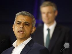 Sadiq Khan, Labour Party candidate, speaks in front of Zac Goldsmith, Conservative Party candidate, after winning the London mayoral elections, at City Hall in London, Saturday, May 7, 2016. (AP Photo/Kirsty Wigglesworth)