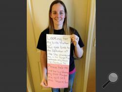 This photo, provided by Katheryn Deprill that she posted on Facebook, shows Deprill holding a sign that says she is seeking her birth mother. Deprill was abandoned in the bathroom of a Burger King restaurant in Allentown when she was a few hours old. Deprill met her biological mother for the first time Monday, March 24 in an attorney’s office. Deprill said Tuesday that she felt “pure joy” and that it was like “looking in a mirror.” (AP Photo/Katheryn Deprill)
