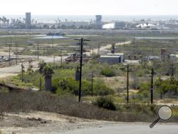 This Aug. 18, 2016 photo shows Banning Ranch, including what remains of an oil-extraction operation, on what is believed to be the biggest piece of privately-owned vacant land on Southern California's coast in Newport Beach. Developers want to build 895 homes and a 75-room resort hotel on the 401-acre swath of land in upscale Newport Beach. (AP Photo/Nick Ut)