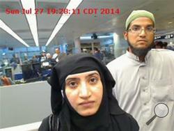 This July 27, 2014, photo provided by U.S. Customs and Border Protection shows Tashfeen Malik, left, and Syed Farook, as they passed through O'Hare International Airport in Chicago. (U.S. Customs and Border Protection via AP)