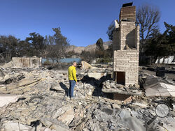 Ryan Pearson, a Los Angeles-based entertainment video editor for The Associated Press, surveys his home that was destroyed by the Eaton Fire, Wednesday, Jan. 15, 2025, in Altadena, Calif. (AP Photo/Ryan Pearson)