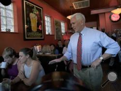 Republican vice presidential candidate, Indiana Gov. Mike Pence, right, surprises patrons at Millie's Diner in Richmond, Va. Saturday, Aug. 27, 2016, during an impromptu visit by the candidate to the popular restaurant. (Bob Brown/Richmond Times-Dispatch via AP)