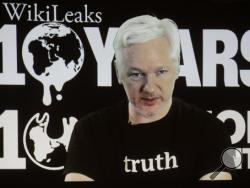 In this Oct. 4, 2016 file photo, WikiLeaks founder Julian Assange participates via video link at a news conference marking the 10th anniversary of the secrecy-spilling group in Berlin. Assange may be stuck in the Ecuadorean Embassy and cut off from the internet, but he's closer than ever to testing a hypothesis he first outlined nearly a decade ago. Can total transparency defeat an entrenched group of insiders? (AP Photo/Markus Schreiber, File)
