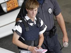 FILE - In this June 18, 2015 file photo, Charleston, S.C., shooting suspect Dylann Storm Roof is escorted from the Cleveland County Courthouse in Shelby, N.C. Prosecutors who wanted to show that Roof was a cruel, angry racist simply used his own words at his death penalty trial on charges he killed nine black people in June 2015 at a Charleston church. Roof's two-hour videotaped confession less than a day after the shooting and a handwritten journal found in his car when he was arrested were introduced into