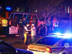 Police talk to a man outside the Emanuel AME Church following a shooting Wednesday, June 17, 2015, in Charleston, S.C. (Wade Spees/The Post And Courier via AP)