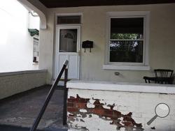 This Saturday, Aug. 2, 2014 photo shows the home where an 8-year-old Pennsylvania boy whose decomposing body was found on the third floor in Harrisburg, Pa. Police charged Jarrod Tutko on Saturday with child endangerment, concealing the death of a child and abuse of a corpse. Harrisburg police said in a statement that Tutko informed his wife about the death of their son, Jarrod Tutko Jr., "when the odor of decomposition became too strong." (AP Photo/PennLive.com, Sean Simmers)