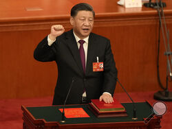 Chinese President Xi Jinping takes his oath after he is unanimously elected as President during a session of China's National People's Congress (NPC) at the Great Hall of the People in Beijing, Friday, March 10, 2023. Chinese leader Xi Jinping was awarded a third five-year term as president on Friday, putting him on track to stay in power for life. (AP Photo/Mark Schiefelbein)